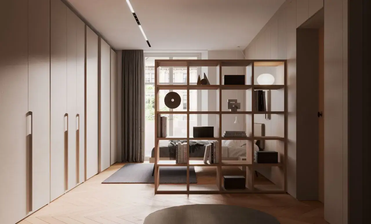 Interno moderno con armadi a muro e libreria divisoria. Un progetto per una casa di 50 mq che massimizza lo spazio.