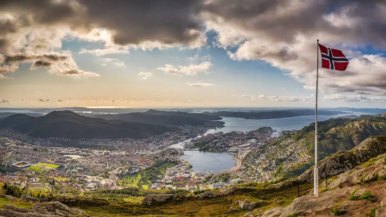 Panorama von Bergen mit norwegischer Flagge. Perfekt für Bergen Sightseeing, mit Blick auf die Stadt und das Meer.