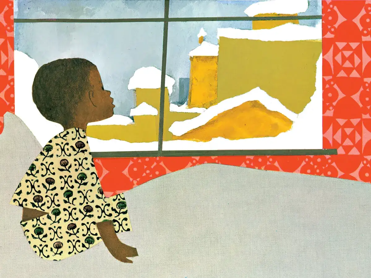 A child in patterned pajamas gazes out a window at snowy day illustrations of yellow buildings covered in white.