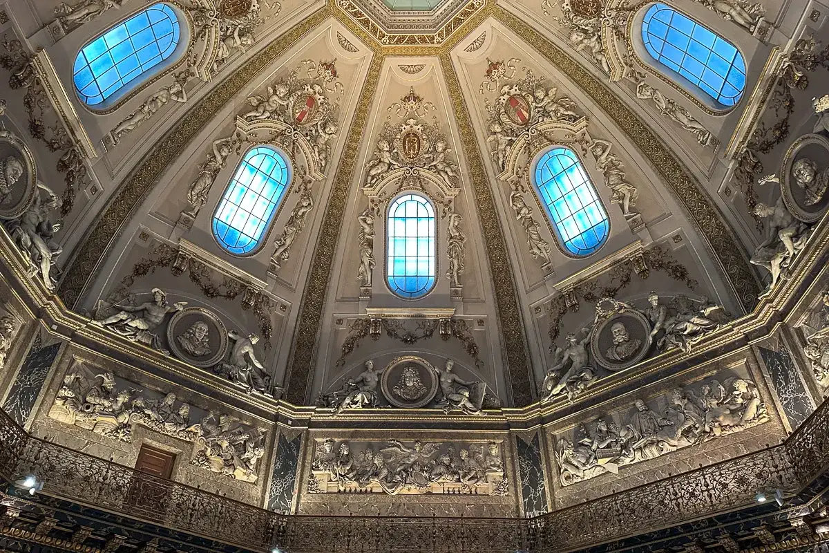 Bogata dekoracja kopuły Muzeum Historii Sztuki w Wiedniu, z błękitnymi oknami i rzeźbami.