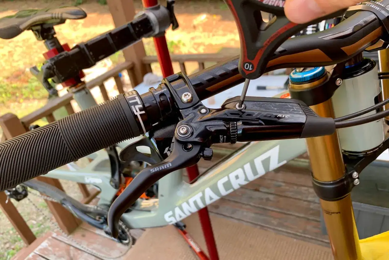 Close-up of a SRAM Guide RSC brakes lever on a Santa Cruz bike. A hex wrench adjusts the lever.