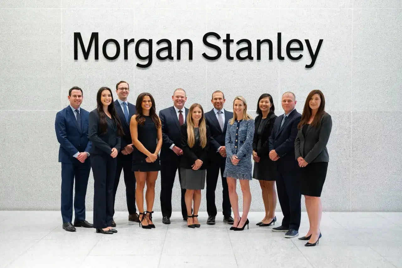 A diverse team poses for a photo under the