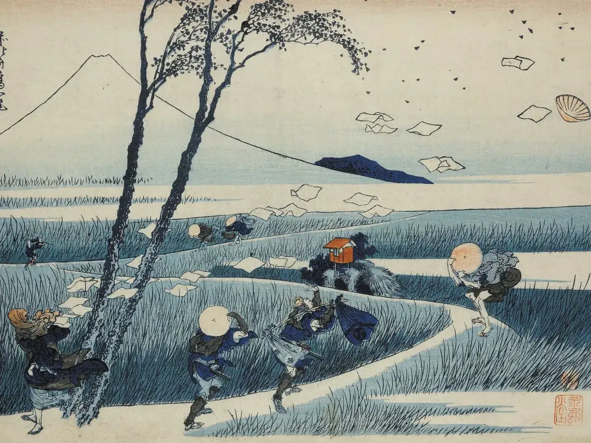 A Katsushika Hokusai artwork depicting travelers struggling against a strong wind, with Mount Fuji in the distance. Papers fly through the air.
