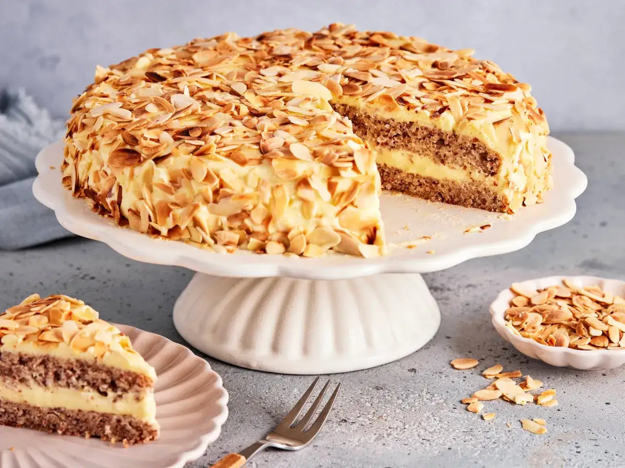 Eine köstliche schwedische Mandeltorte, bedeckt mit gerösteten Mandelblättchen und gefüllt mit cremiger Vanillefüllung. Ein Genuss für jeden Anlass!