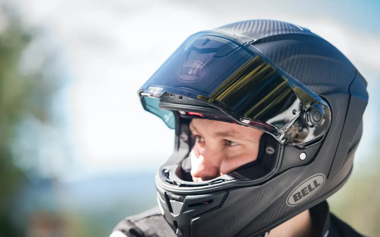 Motocyklista przymierzający kask w sklepie
