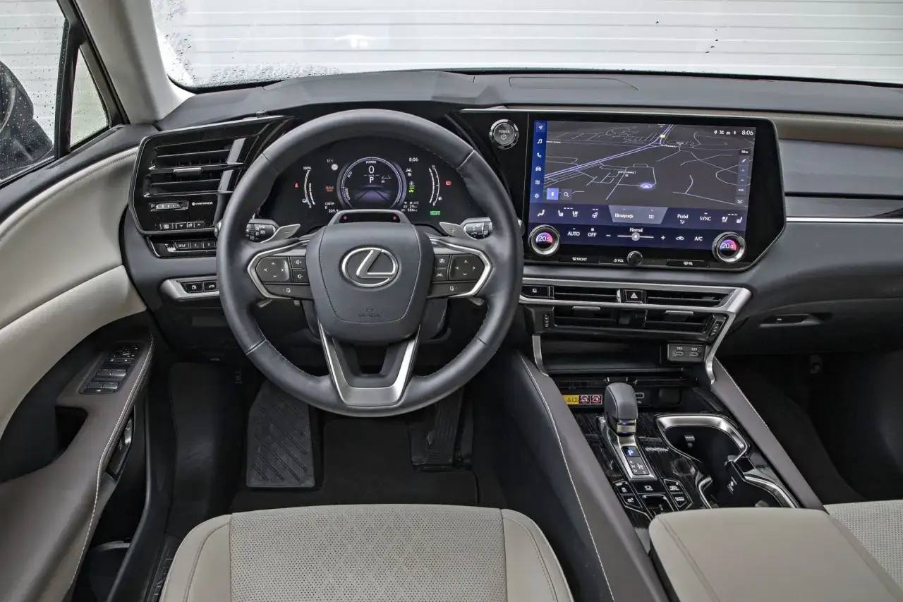 Wnętrze Lexusa RX z ekranem nawigacji i cyfrowymi zegarami. Sprawdź aktualną lexus rx cena i wyposażenie.