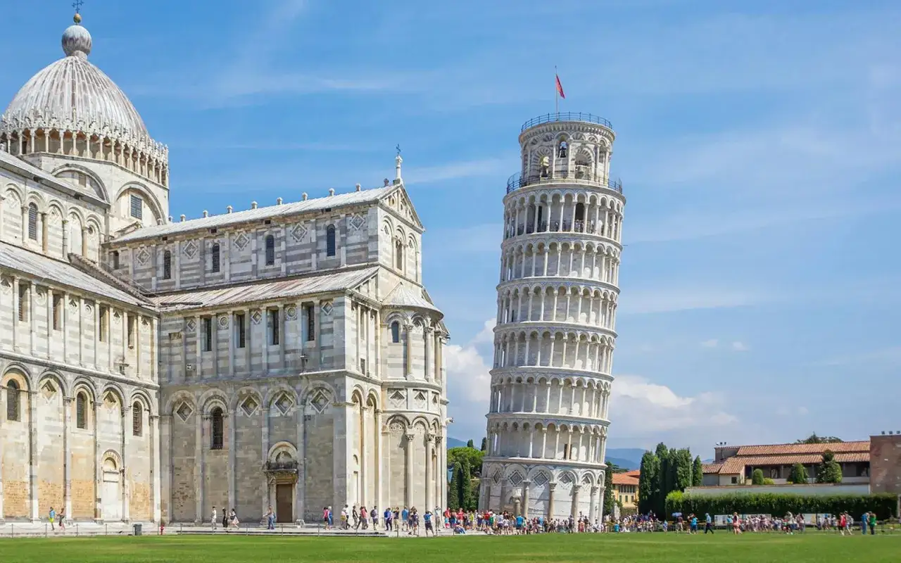 The Leaning Tower of Pisa and the Duomo stand proudly on a sunny day. A perfect destination after arriving at Pisa airport.