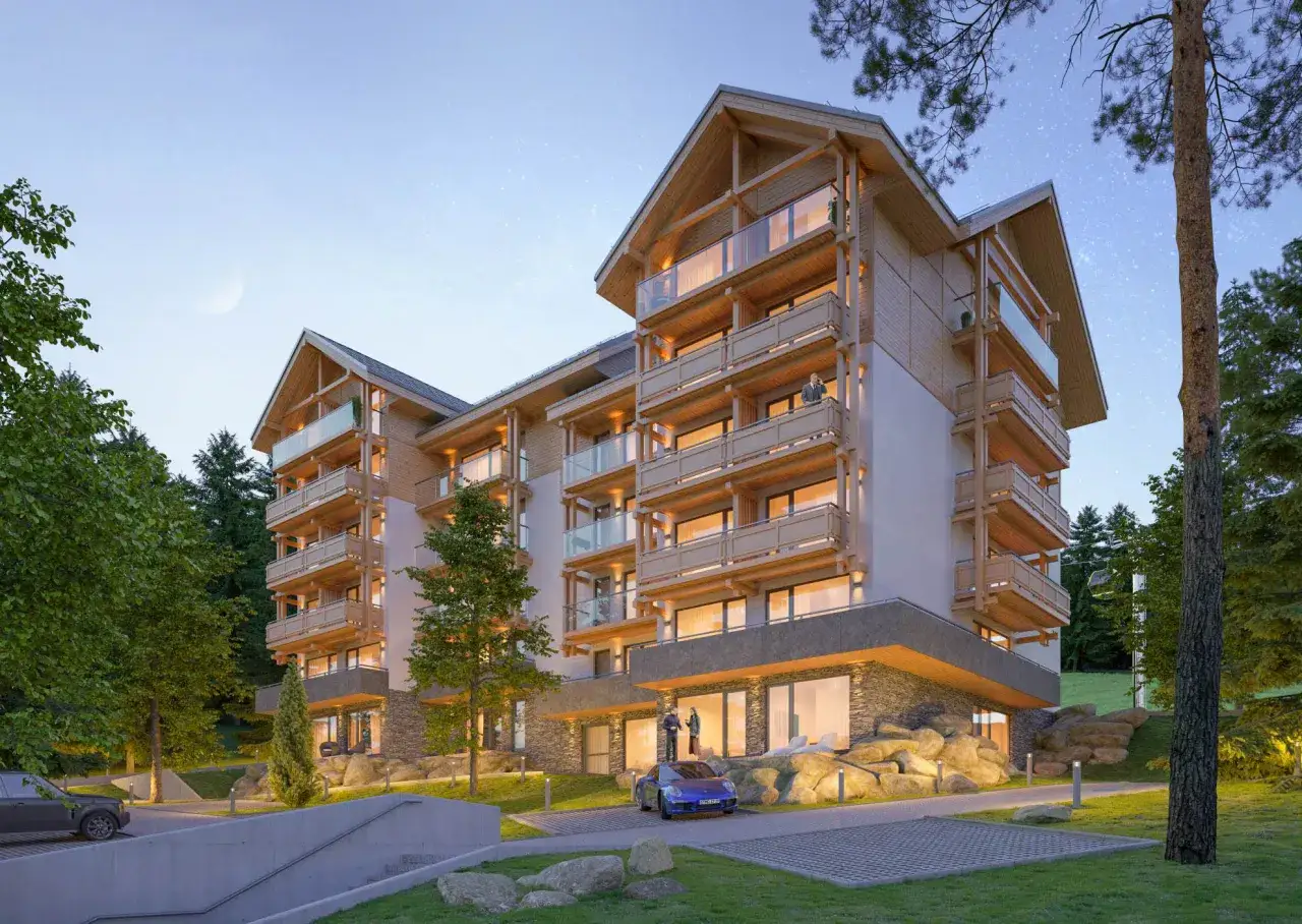 Nowoczesny budynek apartamentowy w górach, idealny do analizy, jak obliczyć yield nieruchomości.