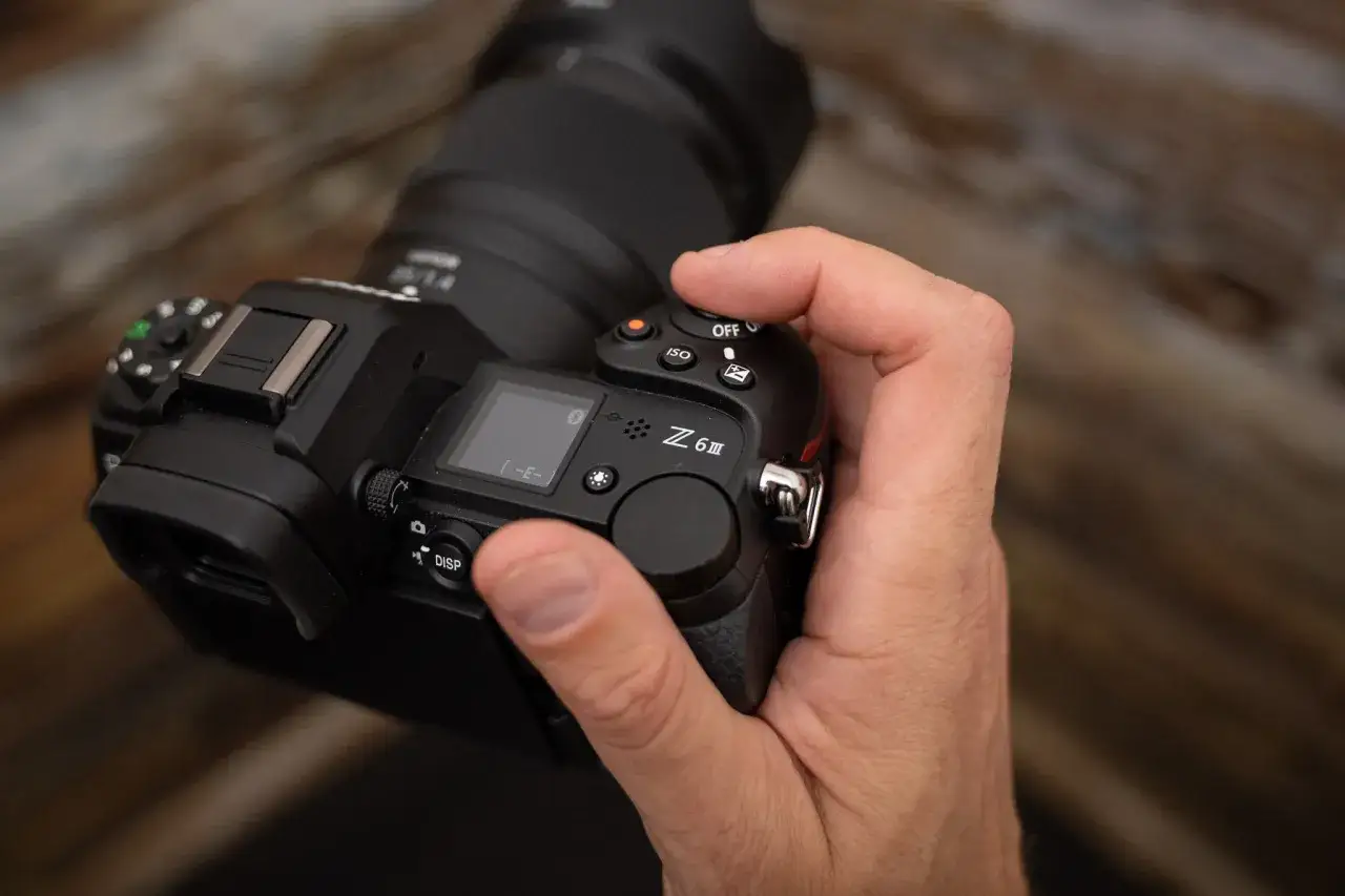 Mano che tiene una Nikon Z6 III, alimentando i rumors sulla sua uscita.