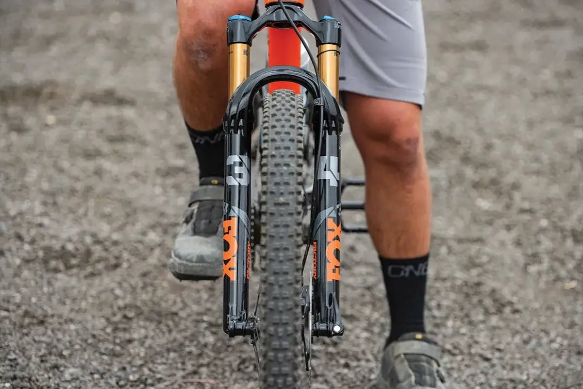 Front view of a mountain bike with a Fox 34 Factory fork, ready for a performance review.
