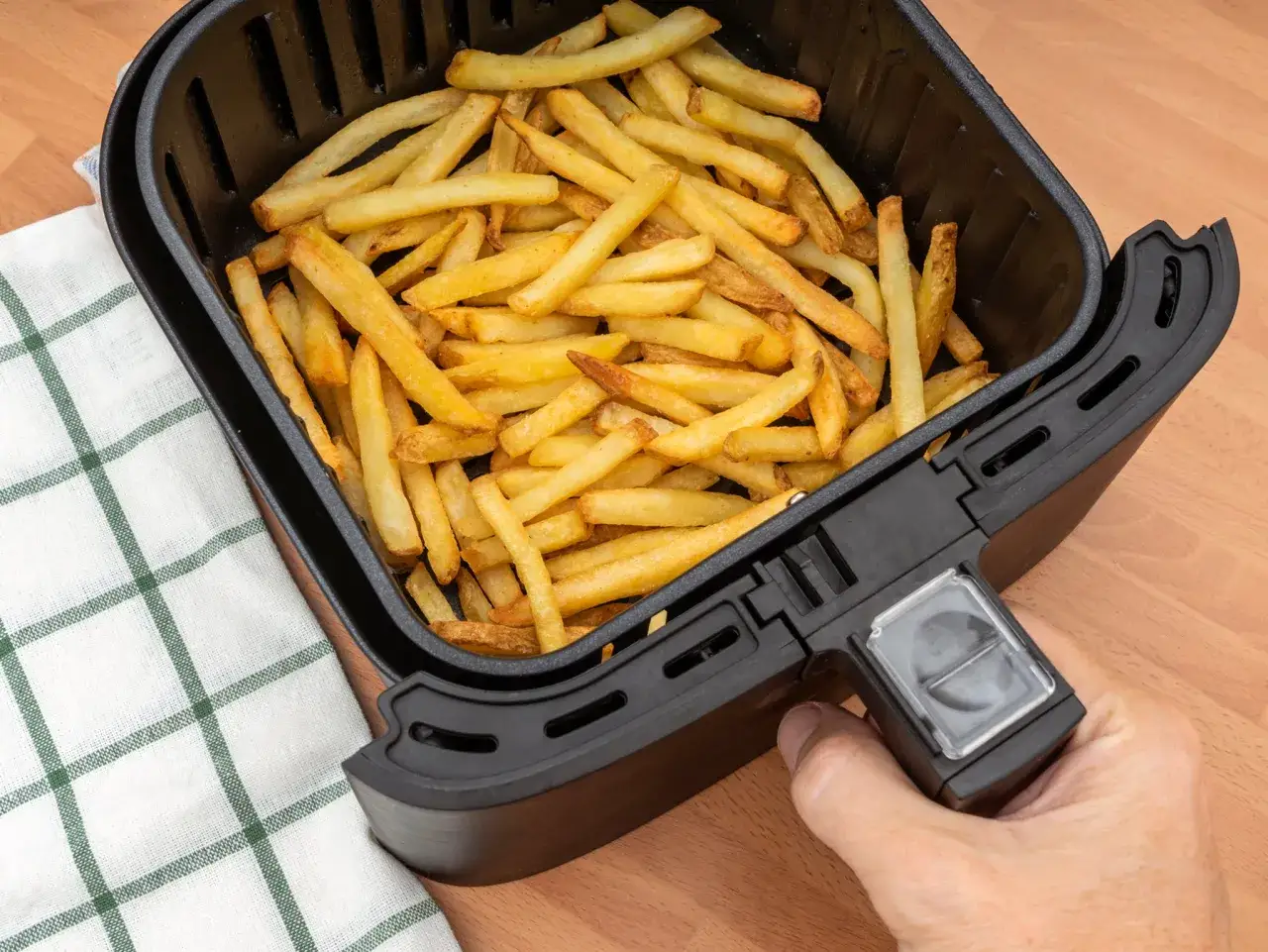 Koszyk z frytkami w gorącym powietrzu. Zobacz, jak działa air fryer, przygotowując chrupiące frytki bez tłuszczu.