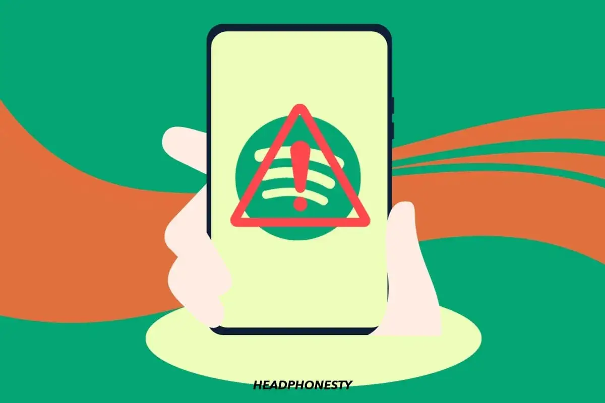 Main tenant de smartphone affichant le logo Spotify barré d'un panneau d'avertissement. Une illustration qui pose la question : pourquoi Spotify ne marche pas ?