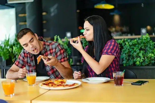 Para jedząca pizzę na randce