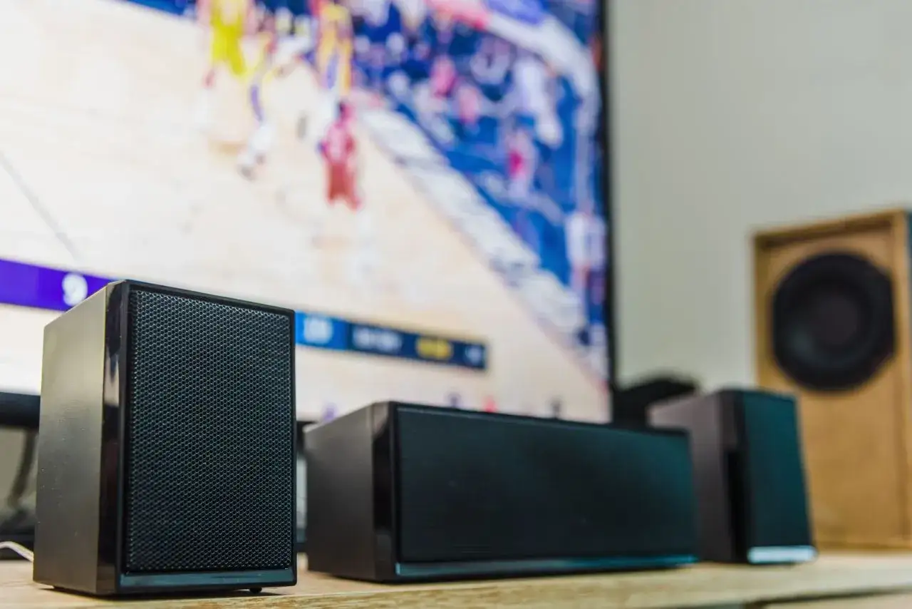 Speakers in front of a TV screen, possibly experiencing chromecast audio delay.