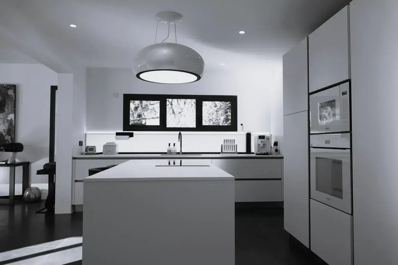 Cuisine moderne 20m2 plan : îlot central, meubles blancs épurés, électroménager intégré, fenêtre panoramique et suspension design.