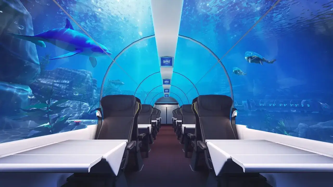 Inside a futuristic train, passengers gaze at dolphins and fish as the train travels underwater. Does the Eurostar go underwater? Not like this!