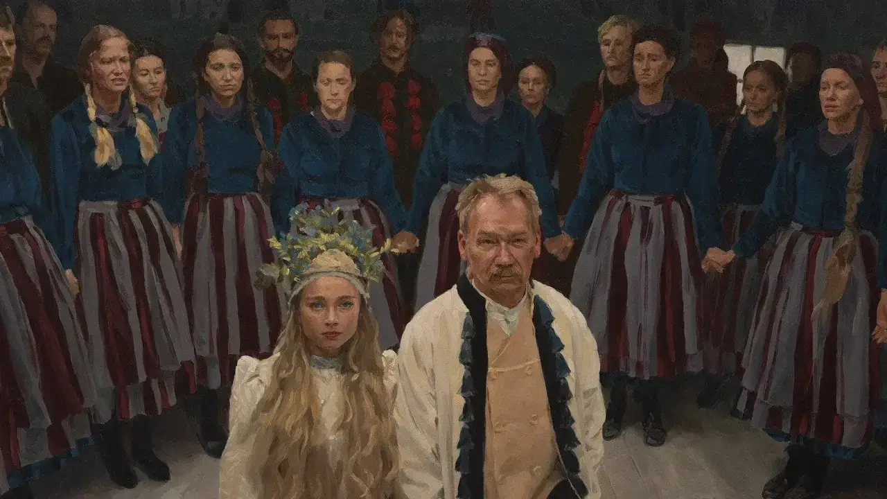 Grupa ludzi w strojach ludowych, wśród nich młoda dziewczyna z wiankiem. W tle widać innych **chłopów** trzymających się za ręce.