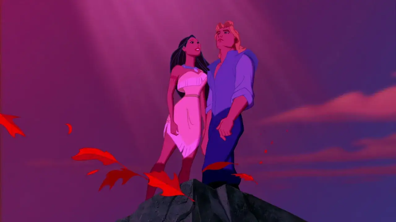 Pocahontas i John Smith stoją na skale, patrząc w górę na fioletowe niebo. Wokół nich unoszą się czerwone liście.
