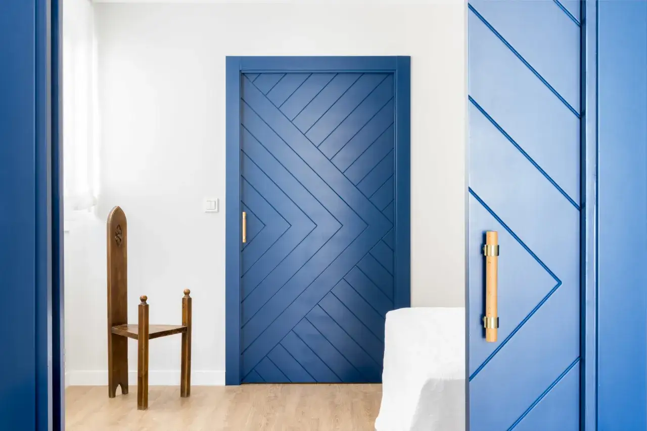 Puertas de diseño moderno en azul vibrante, con un patrón geométrico que crea un efecto visual único. Los tiradores dorados añaden un toque de elegancia.