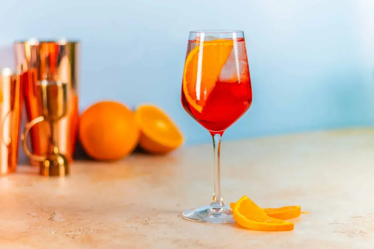 Erfrischender Campari Soda mit Orangenscheibe und Eis. Das perfekte Campari Soda Rezept für heiße Tage.