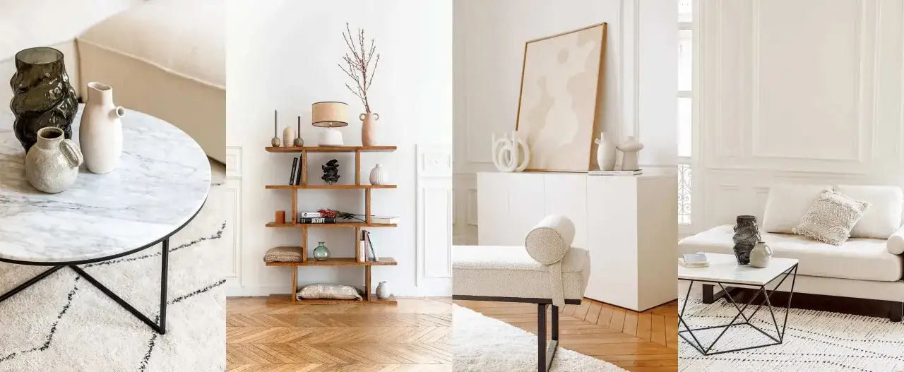 Ein stilvolles Wohnzimmer mit einem Marmortisch, einem B&uuml;cherregal und einem Sofa in der Farbe weiss. Dekorative Vasen und Kissen schm&uuml;cken den Raum.