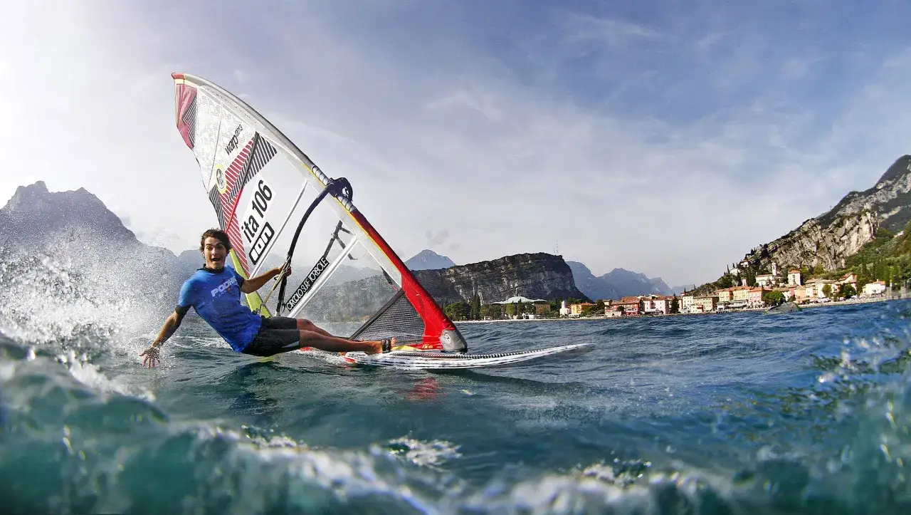 Ludzie uprawiający windsurfing na jeziorze Garda