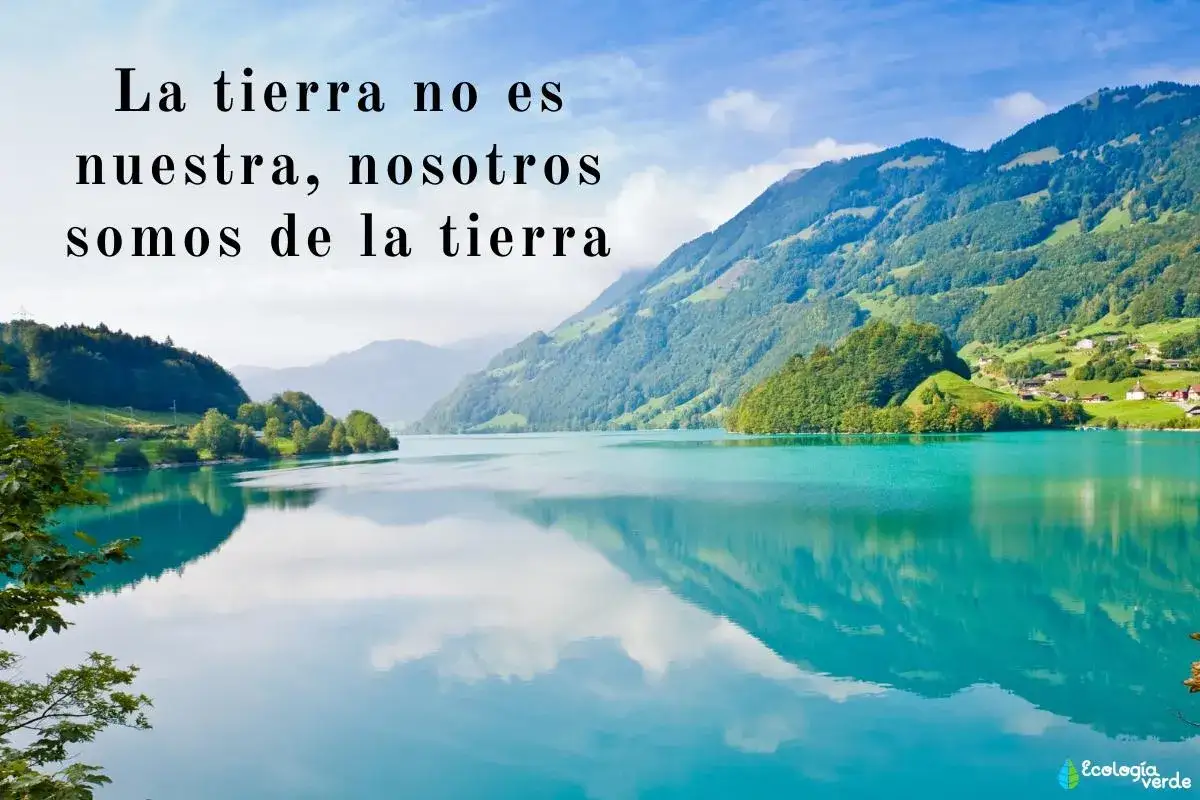 Un lago turquesa refleja monta&ntilde;as verdes y un cielo azul. Frases naturaleza inspiradoras como 