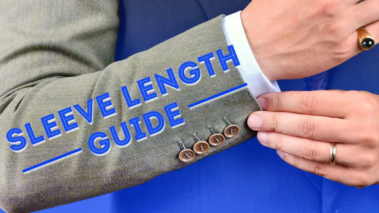 A man adjusts his jacket sleeve, revealing a 