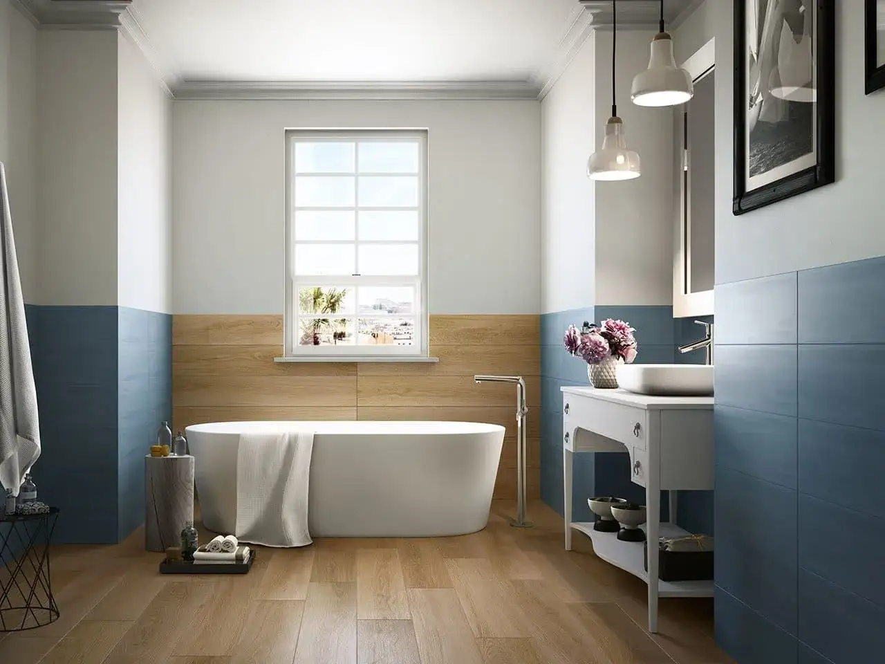 Un elegante bagno azzurro con vasca freestanding, lavabo su mobile bianco e finiture in legno.
