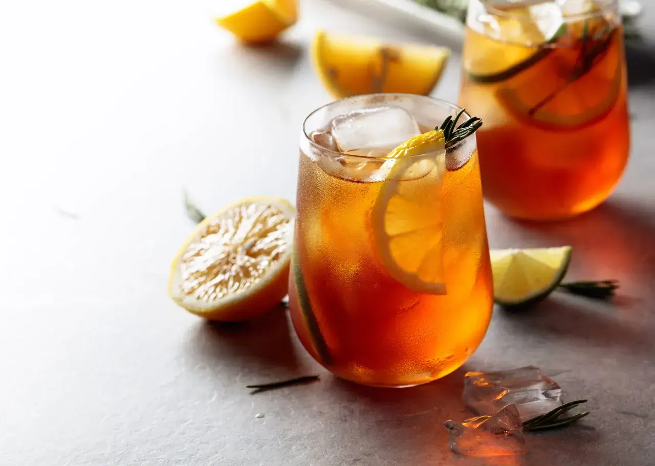 Orzeźwiająca domowa ice tea z cytryną i rozmarynem, podana z lodem. Idealna na upalne dni.