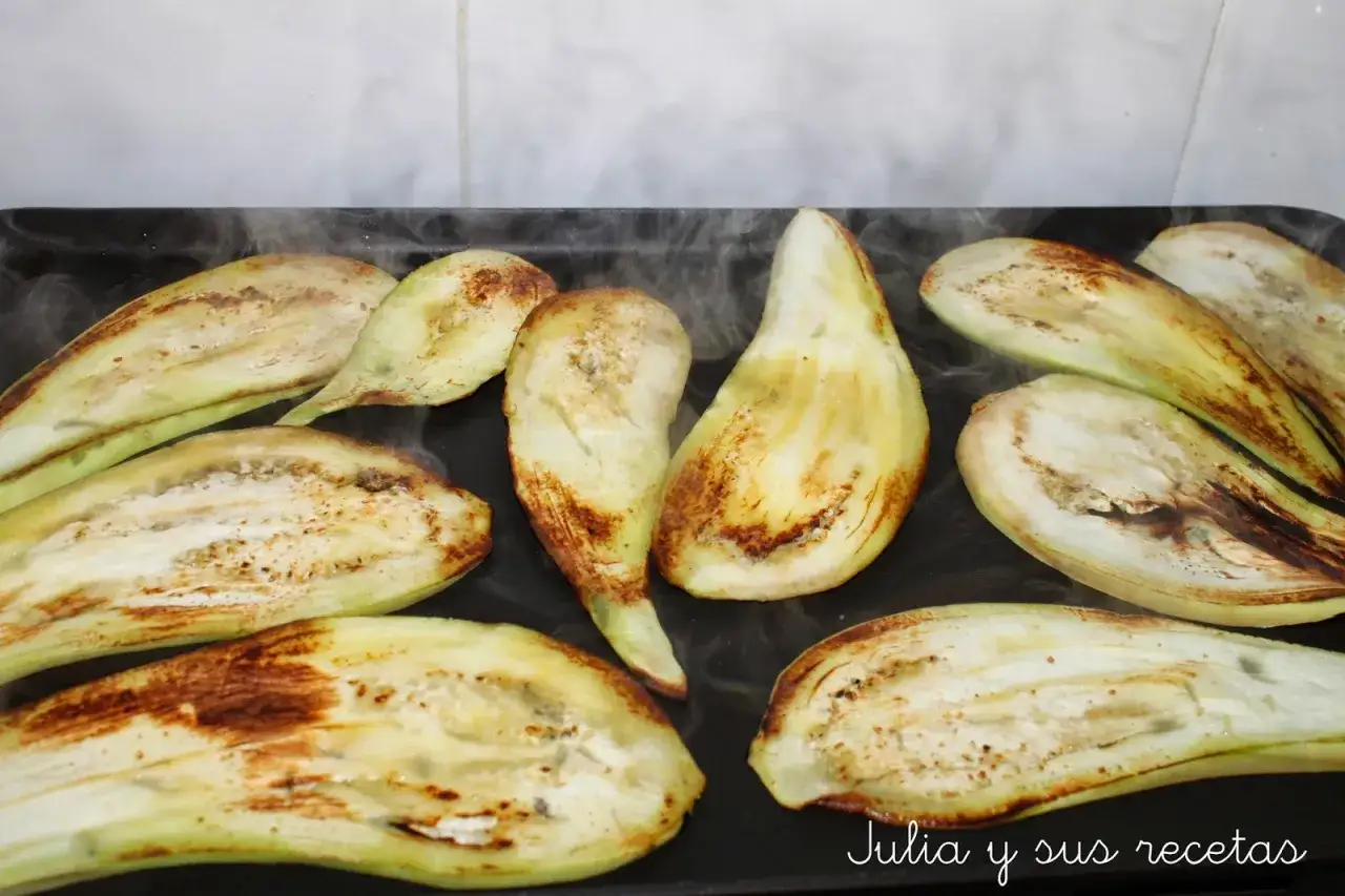 Rodajas de berenjena a la plancha, humeantes y doradas, listas para un delicioso pastel de berenjenas.