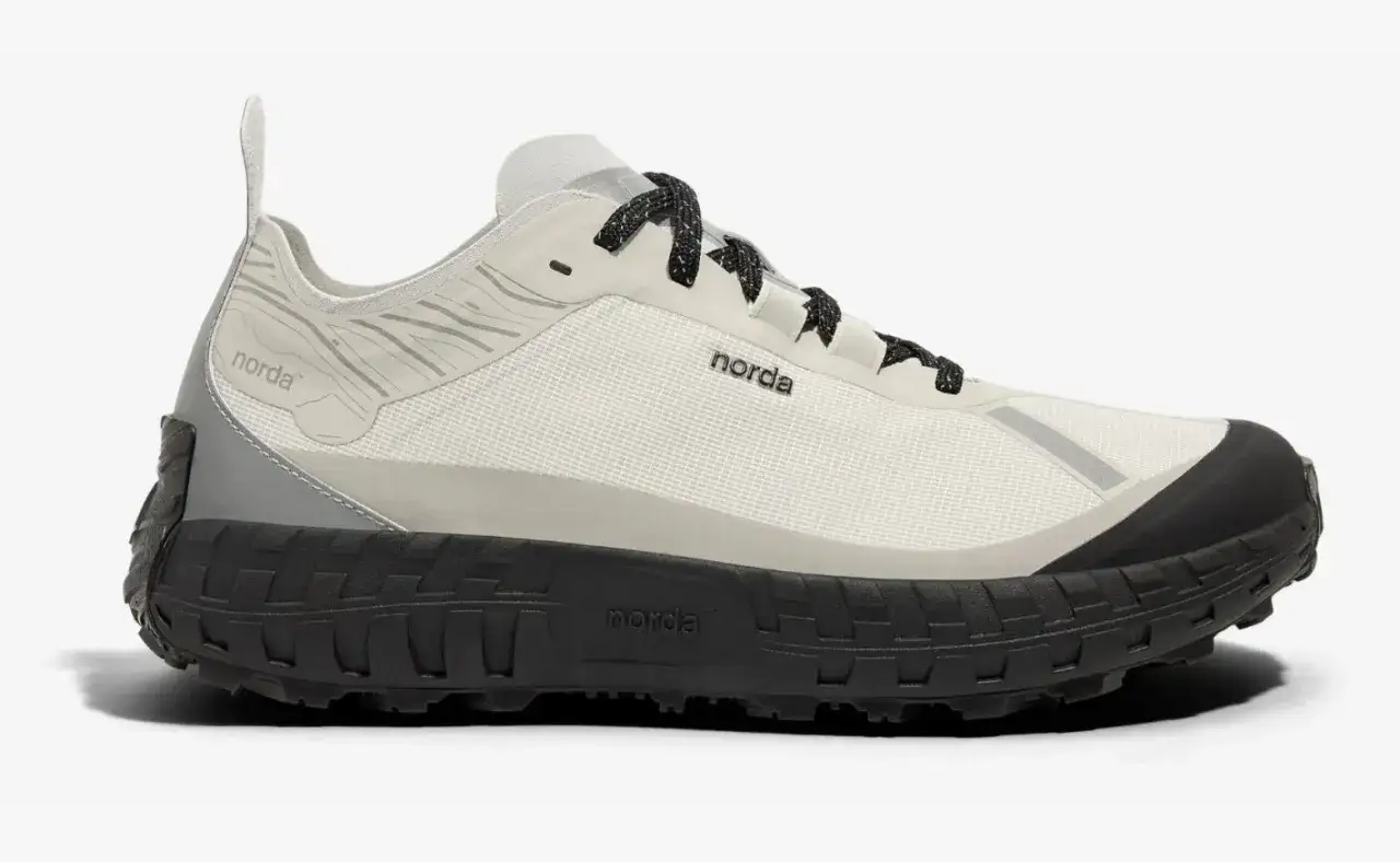 A white and grey norda 001a trail running shoe with a black lugged sole and black laces.