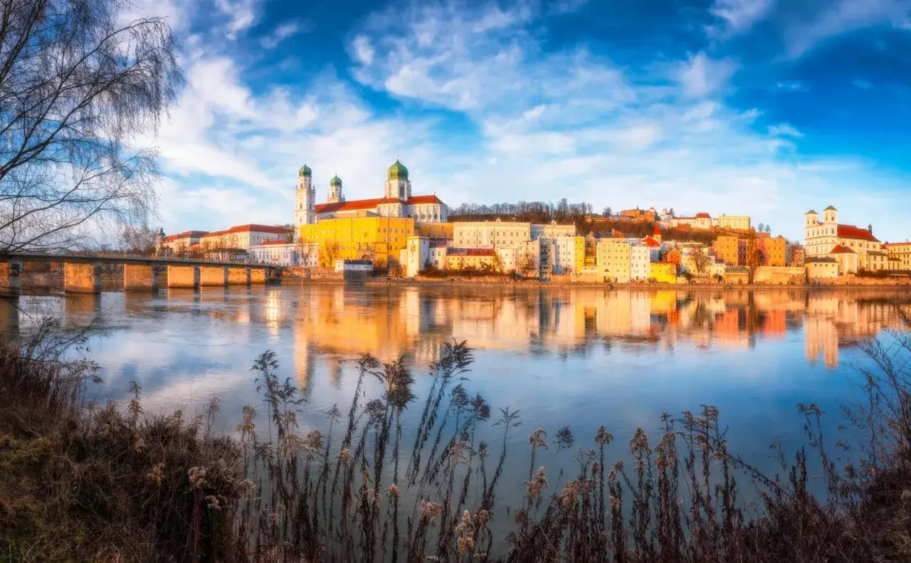 Widok na miasto Passawa nad Dunajem, jedno z najpiękniejszych miast w Niemczech, z mostem i odbijającymi się w wodzie budynkami.