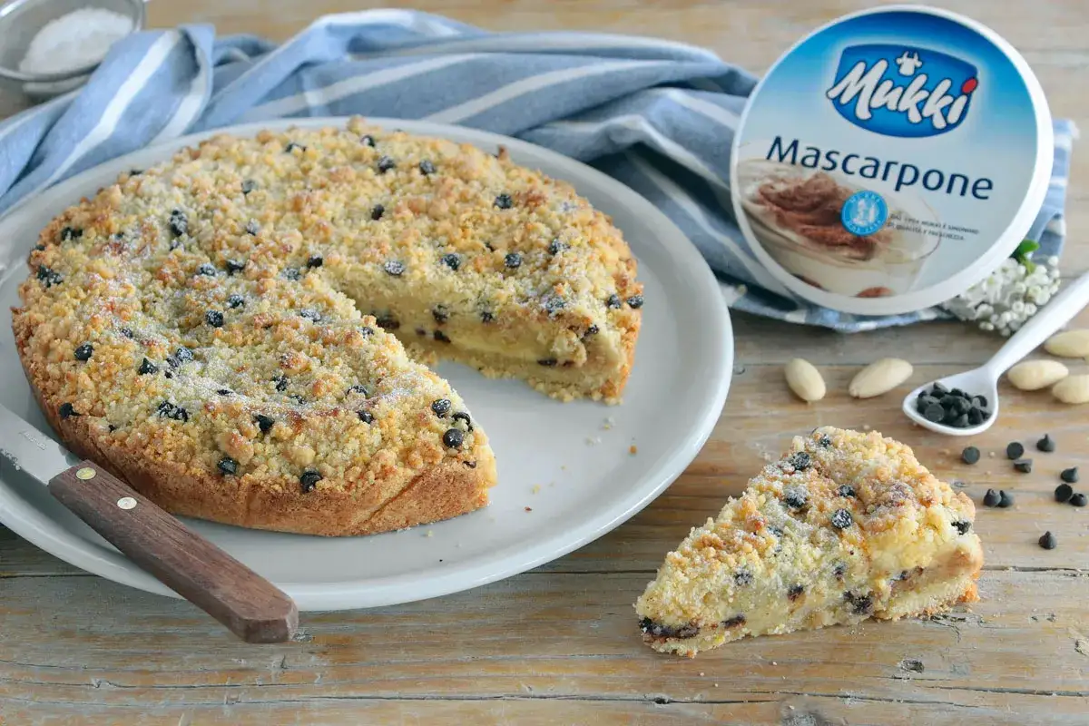 Deliziosa torta con mascarpone e gocce di cioccolato, cosparsa di crumble croccante e zucchero a velo.