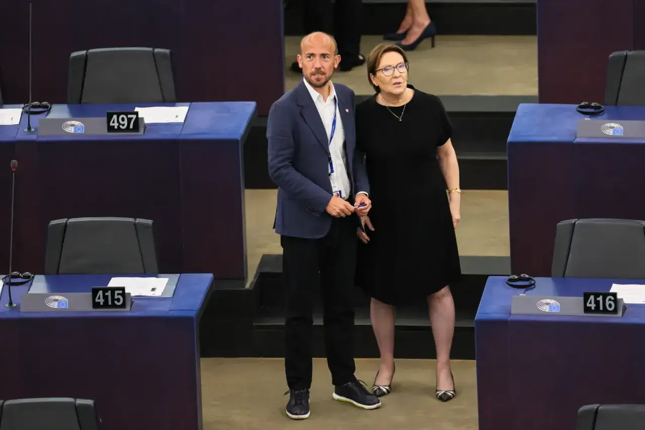 Ewa Kopacz w czarnej sukience i mężczyzna w granatowej marynarce stoją w sali plenarnej. Czy Ewa Kopacz dostała się do Sejmu?