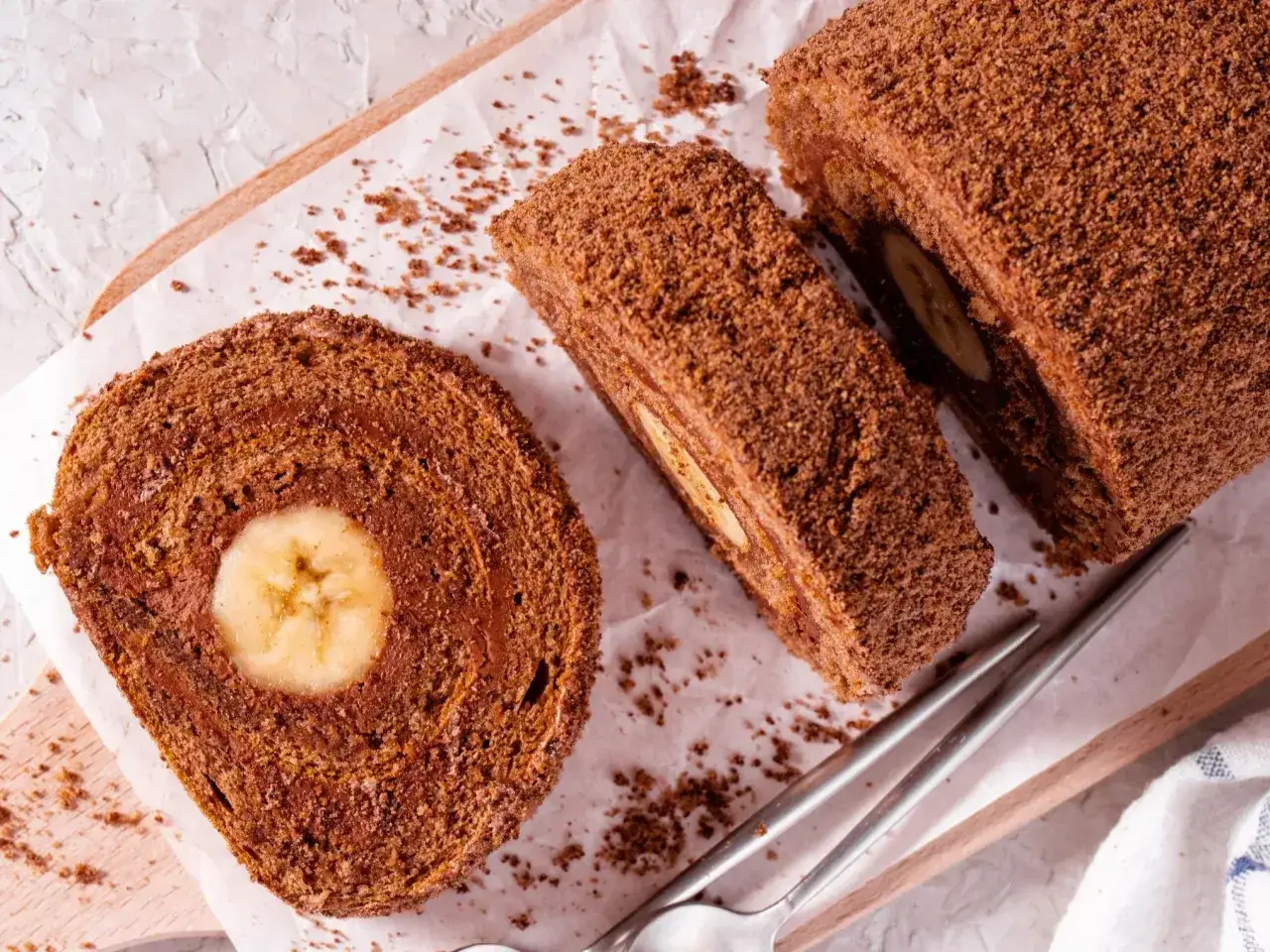 Pyszna rolada biszkoptowa z bananem w środku, posypana kakaową posypką. Idealna na deser.