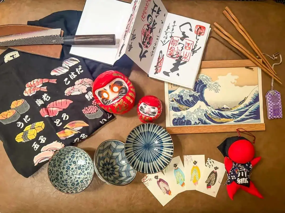 Co kupić w Japonii? Wspaniałe pamiątki: nóż, fartuszek z sushi, darumy, miseczki, pałeczki, obraz z falą i amulety.