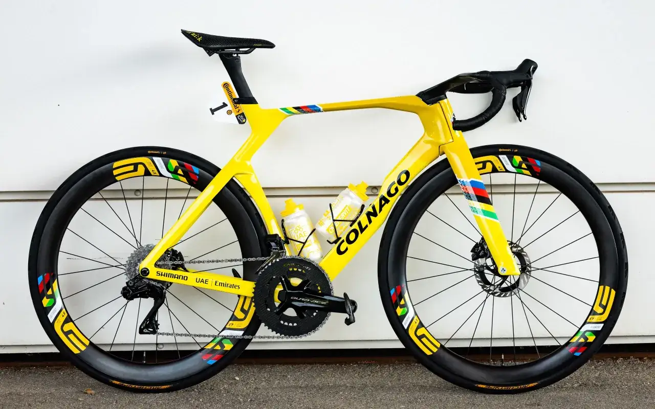 A bright yellow Colnago bike, ready for a champion like Pogacar in the Tour de France, with the number 1 sticker and UAE Emirates branding.