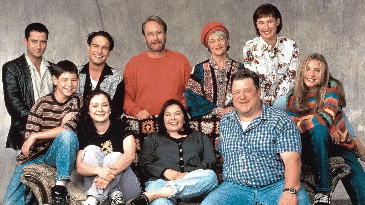 Die Besetzung von Roseanne: Die Familie Conner posiert lächelnd für ein Gruppenfoto.