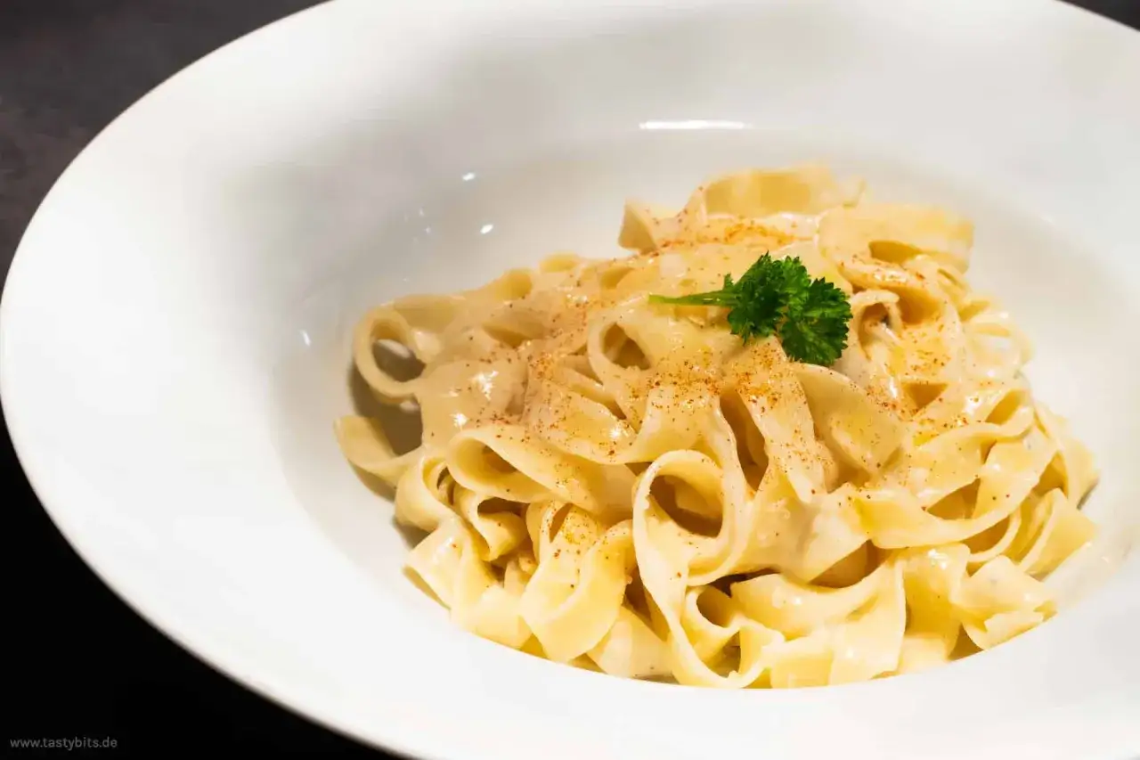 Cremige Pasta mit K&auml;sesauce, bestreut mit Paprikapulver und garniert mit Petersilie. Ein k&ouml;stliches Mac and Cheese Gericht.