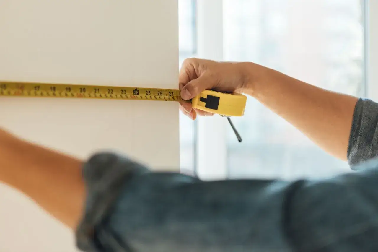 Midiendo una pared para calcular cuánta pintura se necesita por m2.