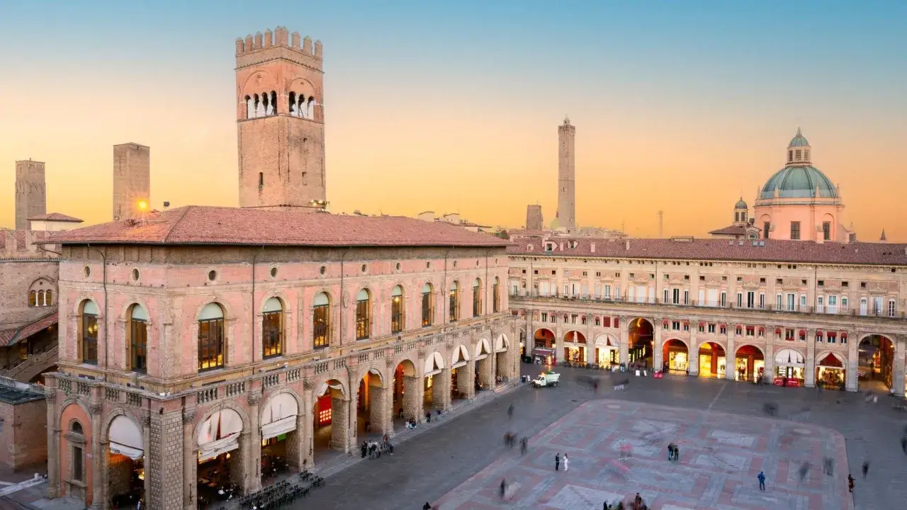 Bologna bei Sonnenuntergang: Wie viele Tage braucht man, um diese Türme und Arkaden zu erkunden? Ein Platz voller Geschichte.