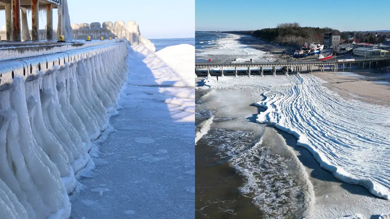 Lodowe sople zwisają z molo, a plaża pokryta jest lodem. Czy bałtyk zamarzł teraz? Widać zamarznięte fale i łodzie na brzegu.