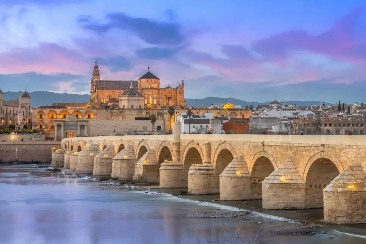 Roman bridge in Cordoba at dusk. The Mezquita-Cathedral looms behind. You could spend many days in Cordoba exploring its history.