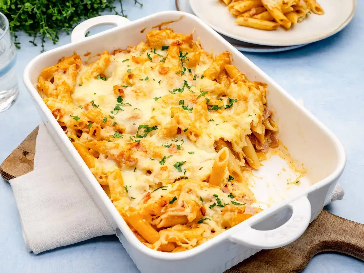 Herzhaftes Nudel Schinken Gratin, überbacken mit geschmolzenem Käse und garniert mit Petersilie. Ein Genuss für die ganze Familie.