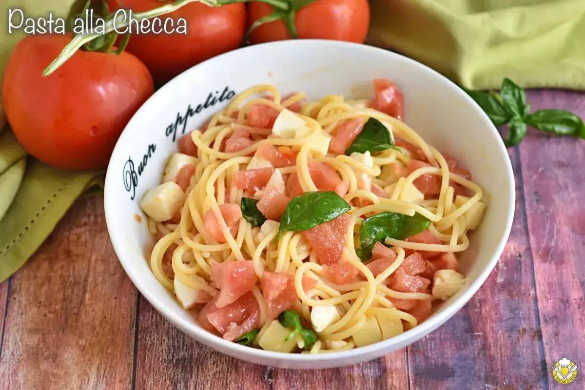 Spaghetti freschi con pomodorini, mozzarella e basilico, un piatto estivo perfetto: pasta alla checca.