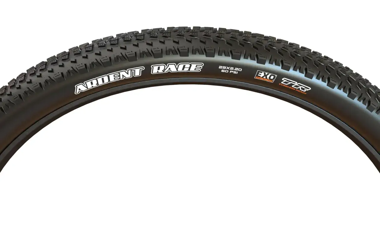 A close-up of a Maxxis Ardent Race 29x2.20 tire, featuring EXO Protection and Tubeless Ready technology, ready for any trail.