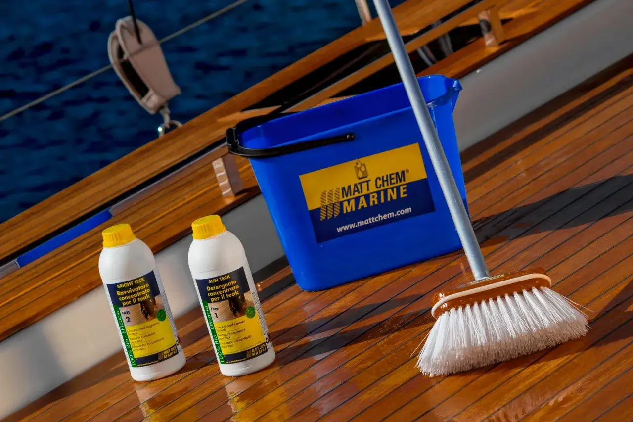 Kit pour le nettoyage du pont de bateau : seau bleu, deux bouteilles de produits pour teck et une brosse.