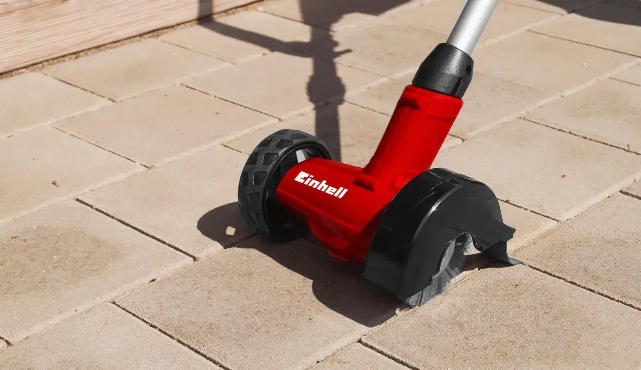 Rote Bürste mit Rädern für das **betonpflaster reinigen**. Ideal für Fugenreinigung und Moosentfernung.