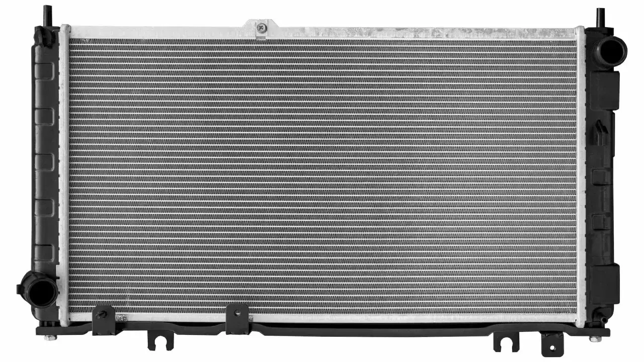 A new car radiator, ready to replace a cracked one. It has a silver aluminum core and black plastic end tanks.